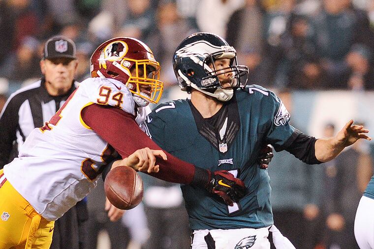 Redskins linebacker Preston Smith (94) strips Sam Bradford (7) of the ball.