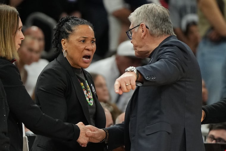 South Carolina head coach Dawn Staley (center) and UConn head coach Geno Auriemma argue after a women's NCAA college basketball tournament semifinal game at the Final Four on Friday.