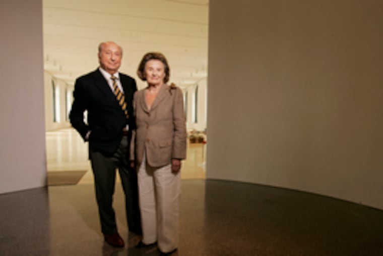 Raymond and Ruth Perelman stand in the entryway to their namesake building's Exhibition Gallery. The couple's gifts - such as the $15 million they gave the Art Museum in 1999 toward the purchase of the building - are made in both names. Likewise, they bought their myriad pieces of art by mutual consent. "There's very little they don't agree upon," their son Ron says.