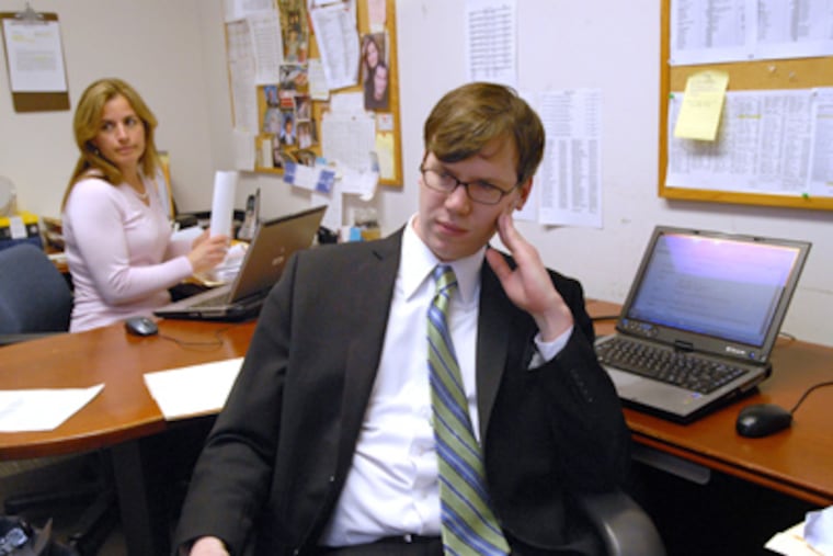 "I do not see myself as a faceless bureaucrat," Assistant Prosecutor Peter
Gallagher says. Behind him is Danielle Curreri, senior data-entry operator. (April Saul / Staff Photographer)