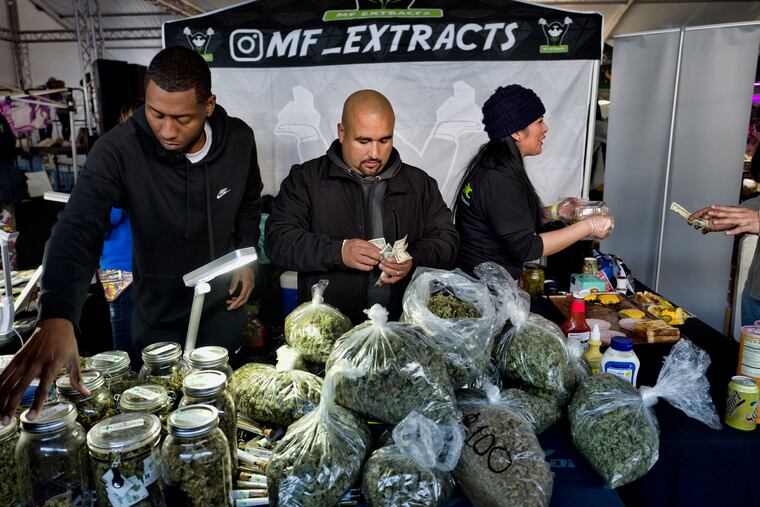 FILE photo shows vendors from MF Extracts counting their intake of cash at their booth at Kushstock 6.5 festival in Adelanto Calif.