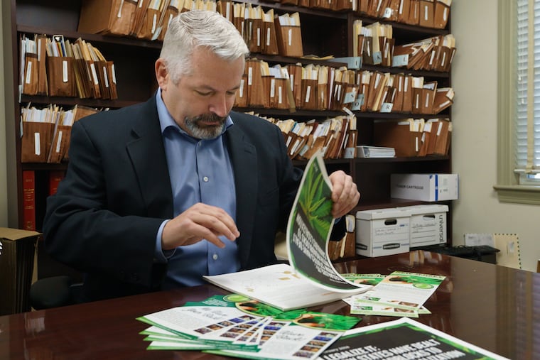 Scott Rudder, president of New Jersey Cannabusiness Association, is shown here with printed materials having to do with the legalization of cannabis, in Haddon Heights, New Jersey, January 4, 2019. JESSICA GRIFFIN / Staff Photographer.