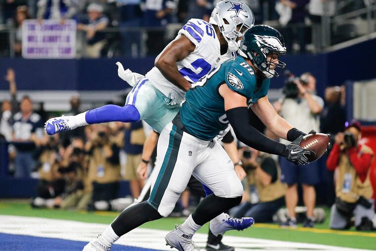 Dallas Goedert catches a fourth-quarter touchdown pass past the Cowboys' Xavier Woods.