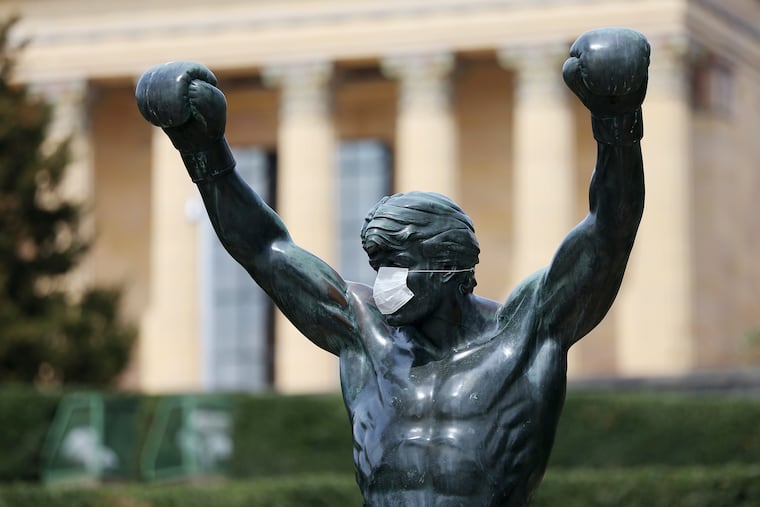A mask covers the face of the Rocky statue in front of the Philadelphia Museum of Art on April 17. People are encouraged to wear masks or face coverings to reduce the spread of the coronavirus.