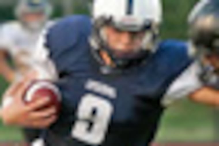 Episcopal Academy QB Adam Strouss stiff-arms a defender during a game against Interboro (no date of game available). (LISA FLORIO)