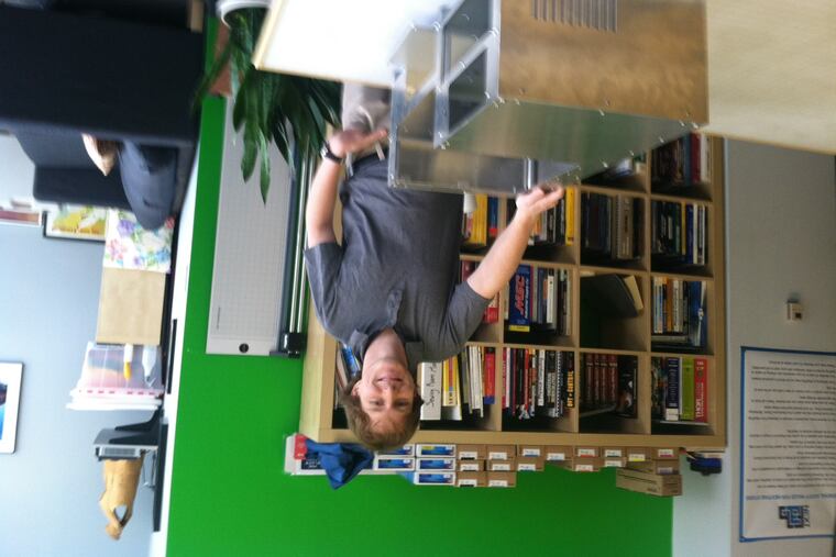 Bernardo Cordovez, of biotech firm Opfluidics, is with an instrument housing made for his company at NextFab Studio in West Philadelphia.