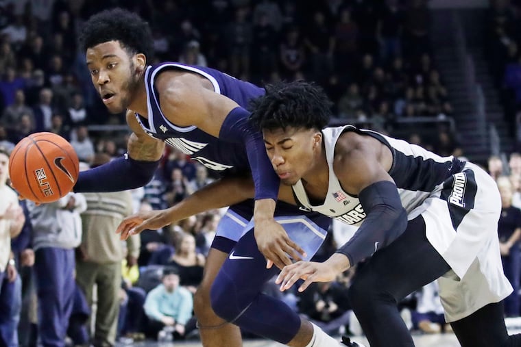 Villanova forward Saddiq Bey, left, controlling the ball against Providence guard David Duke on Saturday.