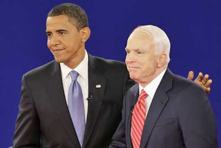 Sen. Barack Obama, left, and Sen. John McCain stand together at the finish of their townhall-style presidential debate at Belmont University on Tuesday. (J. Scott Applewhite/AP Photo)
