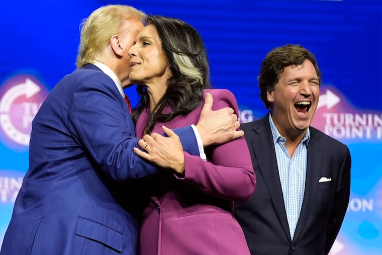 Former Democratic Rep. Tulsi Gabbard embraces Donald Trump as Tucker Carlson yells during an October campaign rally in Duluth, Ga. Choosing the Russia-favoring Gabbard is like delivering an early and glittery Christmas gift to the Kremlin, writes Trudy Rubin.