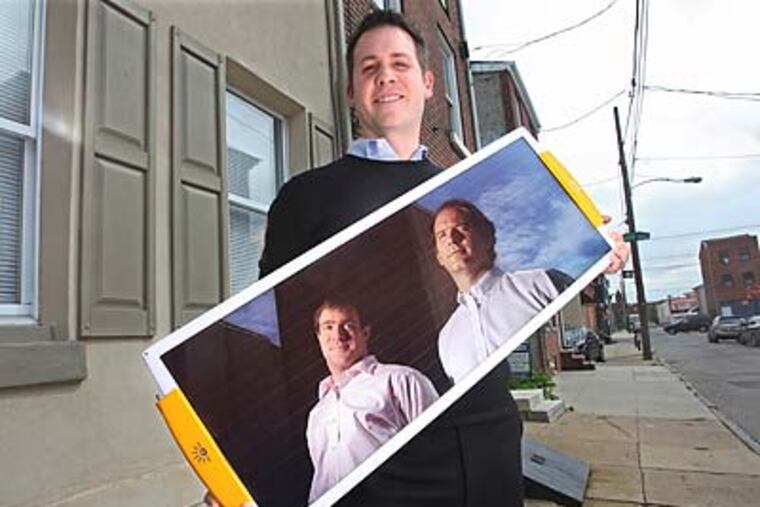 "At the end of the day, the savings are substantial," David Blumenfeld (at right in the solar panel) says of leasing solar power equipment to households. (Michael Bryant/Staff Photographer)