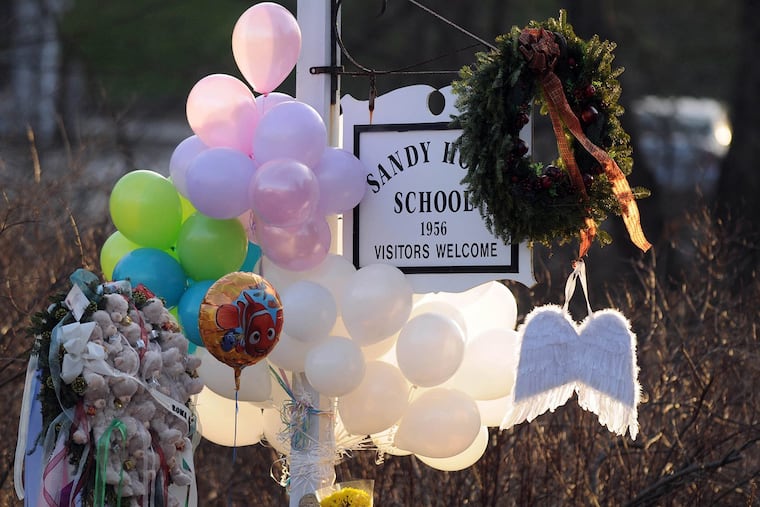 Flowers, teddy bears, candles, balloons and a pair of angel wings left by mourners at the Sandy Hook Elementary School after the mass shooting there in 2012.