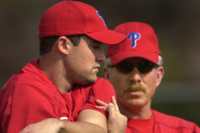 The Phillies' Pat Burrell (left) has talked with Mike Schmidt, who has criticized Burrell's hitting. "It's not a big deal," Burrell said later.