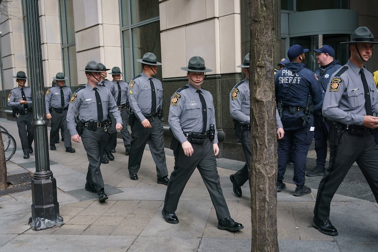 Pennsylvania State Police troopers leave the Criminal Justice Center after the preliminary hearing for Jayana Webb was postponed.