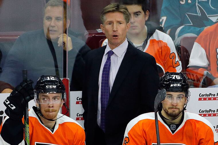 Flyers head coach Dave Hakstol with players Michael Raffl (left) and
Chris VandeVelde.