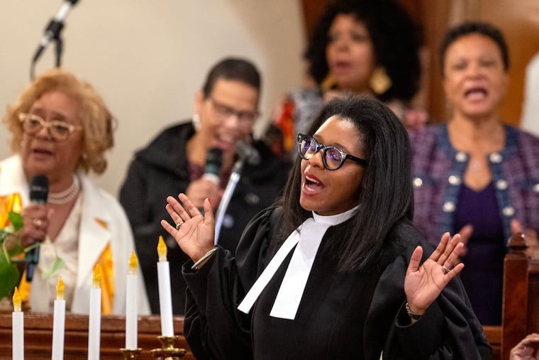 The Rev. Carolyn Cavaness sings with the congregation as she celebrates her first worship service on Sunday, the day after historic Mother Bethel A.M.E. Church appointed her the first female pastor in its 237-year history.