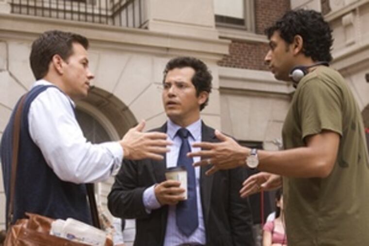 On location for "The Happening," Shyamalan reviews a scene with Mark Wahlberg (left) and John Leguizamo.
