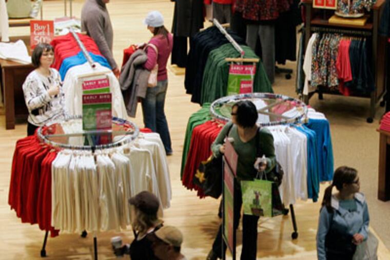 In this Nov. 28, 2008 file photo, shoppers check out Black Friday specials at the Mall of America in Bloomington, Minn. (AP Photo/Jim Mone, file)