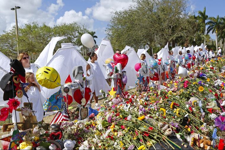 Angels paying tribute at the memorial for the victims of the shooting at Marjory Stoneman Douglas High School on February 25, 2018, during an open house as parents and students returned to the school for the first time since 17 people were killed in a mass shooting at the school in Parkland on February 14.