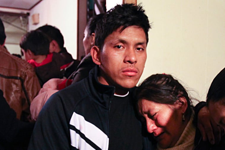 Luis F. Sarmiento's brother Anibal, 24, and mother, Rosa, at their home in Riverside. STEVEN M. FALK / Staff Photographer