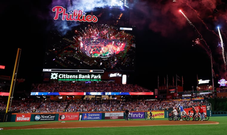 Kids on bikes ride on Citizens Bank Park with fireworks during the MLB All-Star Game on Tuesday, July 14, 2026 in Philadelphia.