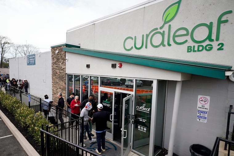 In a file photo, customers enter a Curaleaf dispensary in Bellmawr, N.J. A former employee of a South Philadelphia Curaleaf filed a lawsuit against the company, accusing it of violating the city's Fair Workweek Law.