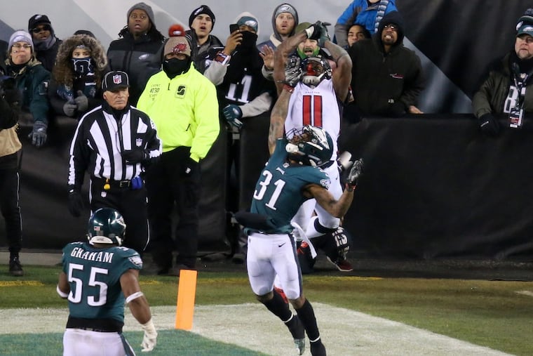Falcons wide receiver Julio Jones (11) couldn’t catch a pass under pressure from Eagles cornerback Jalen Mills (31) late in the Eagles' playoff win against the Falcons at Lincoln Financial Field on Jan. 13.