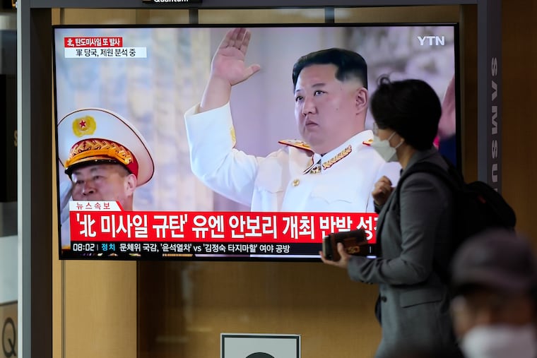 A TV screen showing a news program reporting about North Korea's missile launch with file footage of North Korean leader Kim Jong Un is seen at the Seoul Railway Station in South Korea on Thursday.