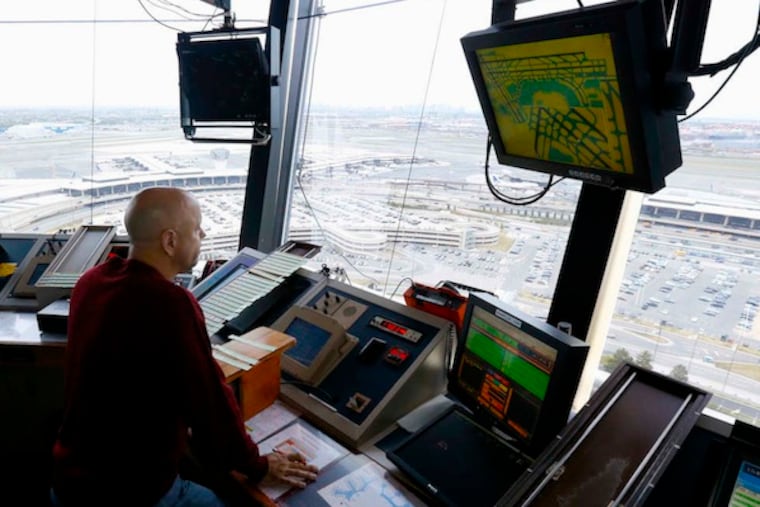 An air traffic controller in the tower at Newark Liberty International Airport. U.S. controllers track 132 million flights annually. (JULIO CORTEZ/AP)