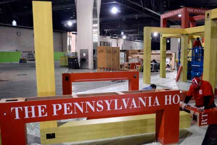 Workers assemble the Pennsylvania Horticultural Society booth at Hawaii: Islands of Aloha theme of the 2013 Philadelphia International Flower Show. TOM GRALISH / Staff Photographer )