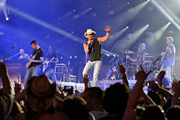 Kenny Chesney performs on the beach in Wildwood. A generation-spanning audience sang along, even to songs from his new album, released this week. ELIZABETH ROBERTSON / Staff Photographer