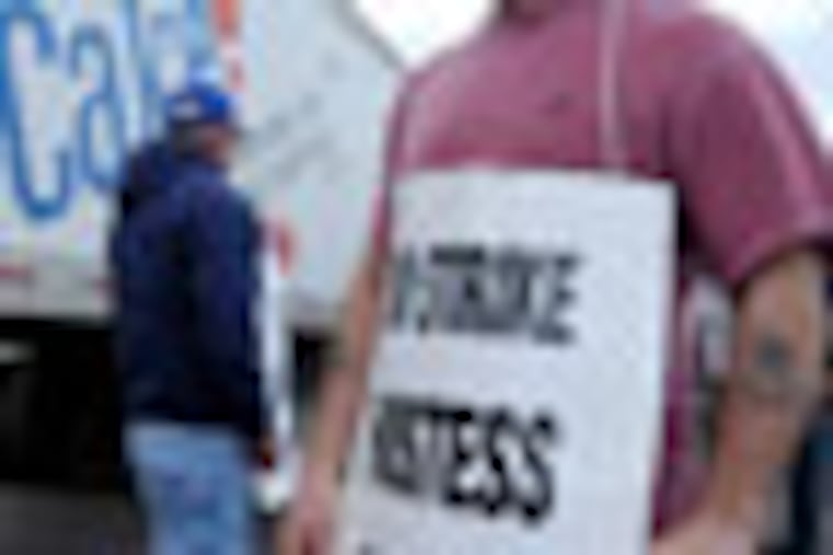 Michael Ducharme (RIGHT), 51, and Michael Bourgault, 54, members of local 334 of the bakery, confectionery, tobacco workers and grain millers international union out of Biddeford, Maine, picket the local Hostess Bakery plant on Blue Grass Road in Northeast Philadelphia Monday, Nov. 12, 2012 trying to keep trucks from entering the plant. Eight union members from Biddeford came to Philadelphia to lead the strike here. ( CLEM MURRAY / Staff Photographer )