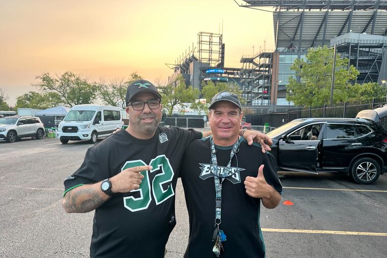 A lifelong Eagles fan, Gregg Matza (left, with Adrian Marshall) has seen the sunrise from the stadium parking lots more times than he can count.