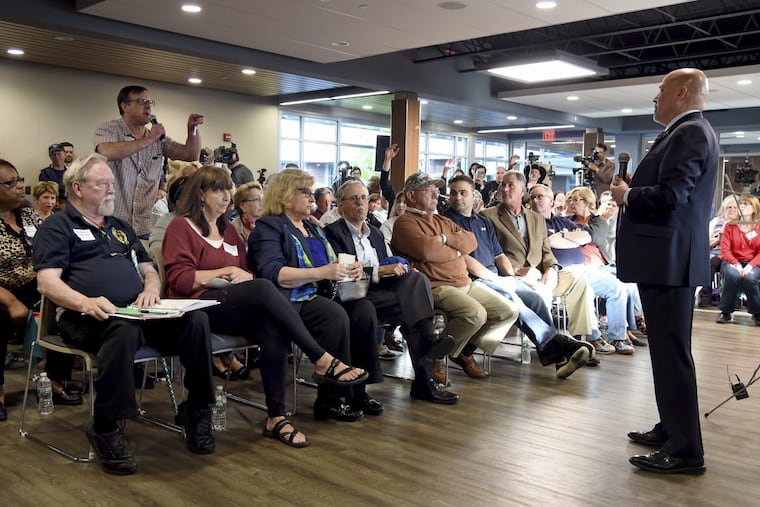 U.S. Rep. Tom MacArthur (right) takes questions during a town hall meeting in Willingboro on May 10.