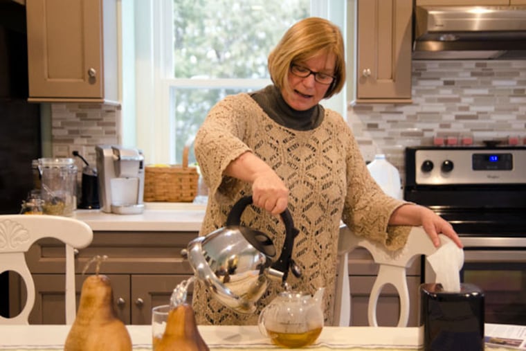Barbara Bitros pours a cup of tea at her Langhorne home. Bitros, who has been experiencing serious memory loss, says she will end her life before she loses her sense of self. She fears dementia far more than death.
