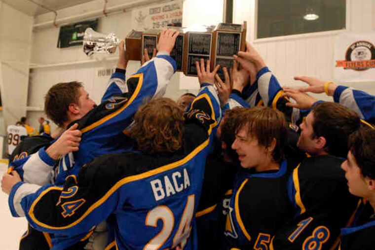 Downingtown East players lift the Flyers Cup after defeating Council Rock South, 4-2, last night to capture the AA championship.