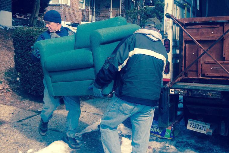 Workers with Pathways to Housing PA’s furniture bank deliver donated furniture to families in need. The bank opened in December and has already helped about 20 families and 13 member agencies furnish their spaces. (HELEN UBINAS / DAILY NEWS STAFF)