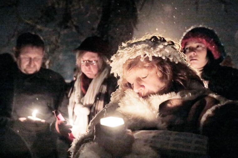 Gayle Brown of Browns Mills closes her eyes during the candlelight vigil for the newborn baby, allegedly set on fire by her mother, at Browns Mills United Methodist Church on Jan. 21, 2015. ( ELIZABETH ROBERTSON / Staff Photographer )