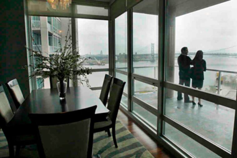 Broker Paul Lipowicz and Laura Ahmes of the auction firm on the deck of a Reef Tower Waterfront Square unit. (Elizabeth Robertson / Staff Photographer)