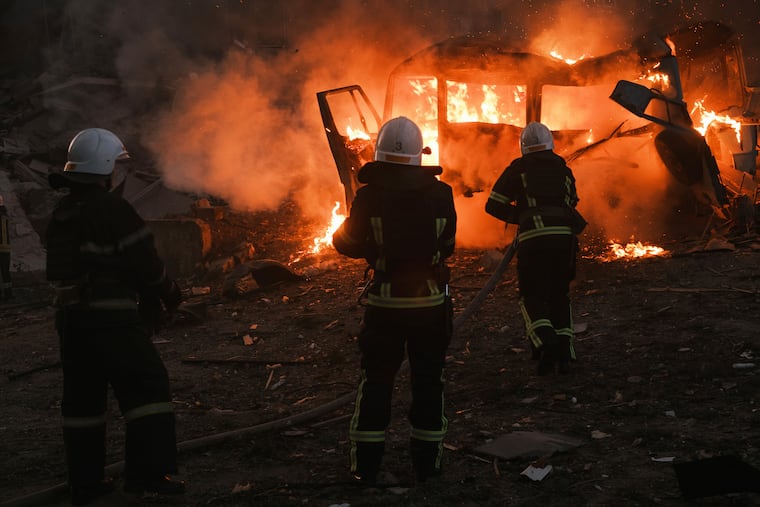 Firefighters worked Saturday at the site of a fire after Russian shelling in Mykolaiv, Ukraine.
