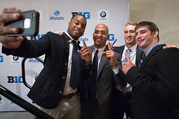 Penn State head coach James Franklin poses for a selfie with running back Bill Belton, kicker Sam Ficken and linebacker Mike Hull. (Joe Hermitt/PennLive.com/AP)
