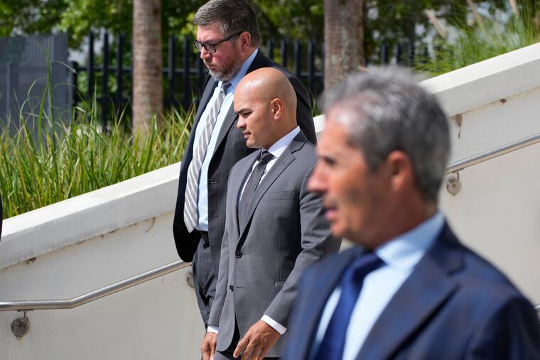 Walt Nauta, center, valet to former president Donald Trump, his attorney Stanley Woodward, rear, and Carlos De Oliveira, foreground, the property manager of Trump's Mar-a-Lago estate, leave the Alto Lee Adams Sr. U.S. Courthouse on Thursday in Fort Pierce, Fla.