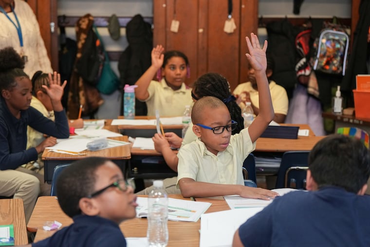 Student Fareed Pitss raises his hand during class at Overbrook Elementary School.