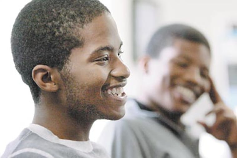 Ralph Alexis (left), 18, with his older brother Ruben, talks about his escape. He returned to Philadelphia Monday. (ELIZABETH ROBERTSON / Staff Photographer)