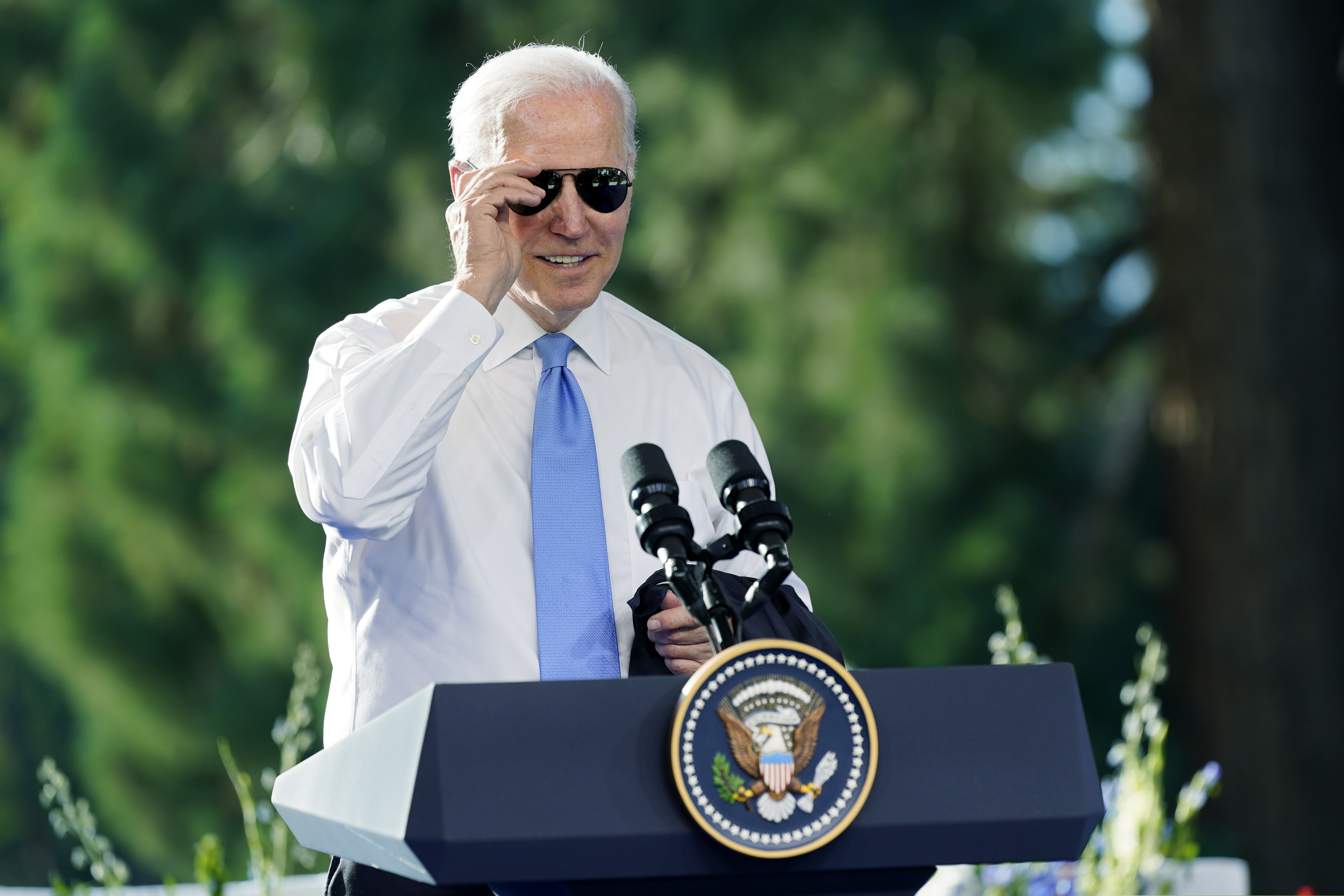 President Joe Biden puts on his sunglasses toward the end of a news conference in 2021. The president has racked up a number of accomplishments without getting much credit.