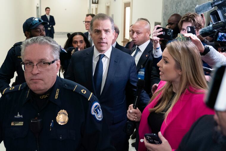 Hunter Biden, President Joe Biden's son, center, leaves a House Oversight Committee hearing as Republicans are taking the first step toward holding him in contempt of Congress on Wednesday on Capitol Hill in Washington.