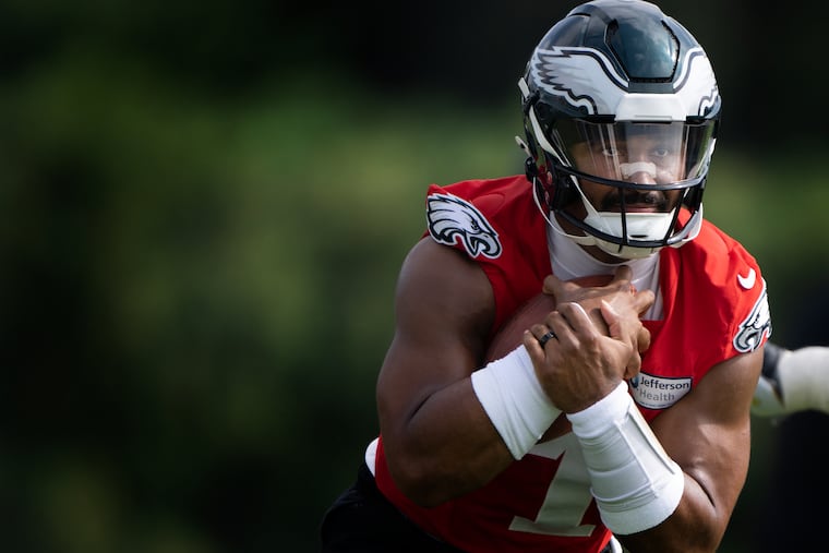 Eagles quarterback Jalen Hurt carries the ball during practice at the NovaCare Complex on Tuesday.