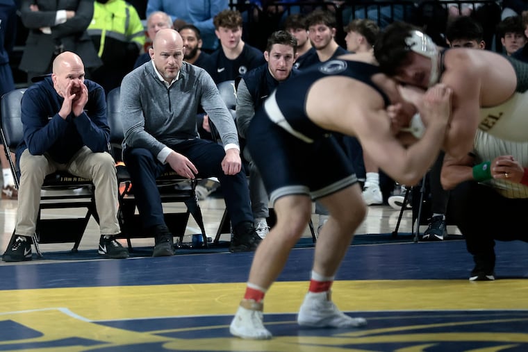 Penn State coach Cael Sanderson (second from left) watching as the Nittany Lions took on Drexel in December.