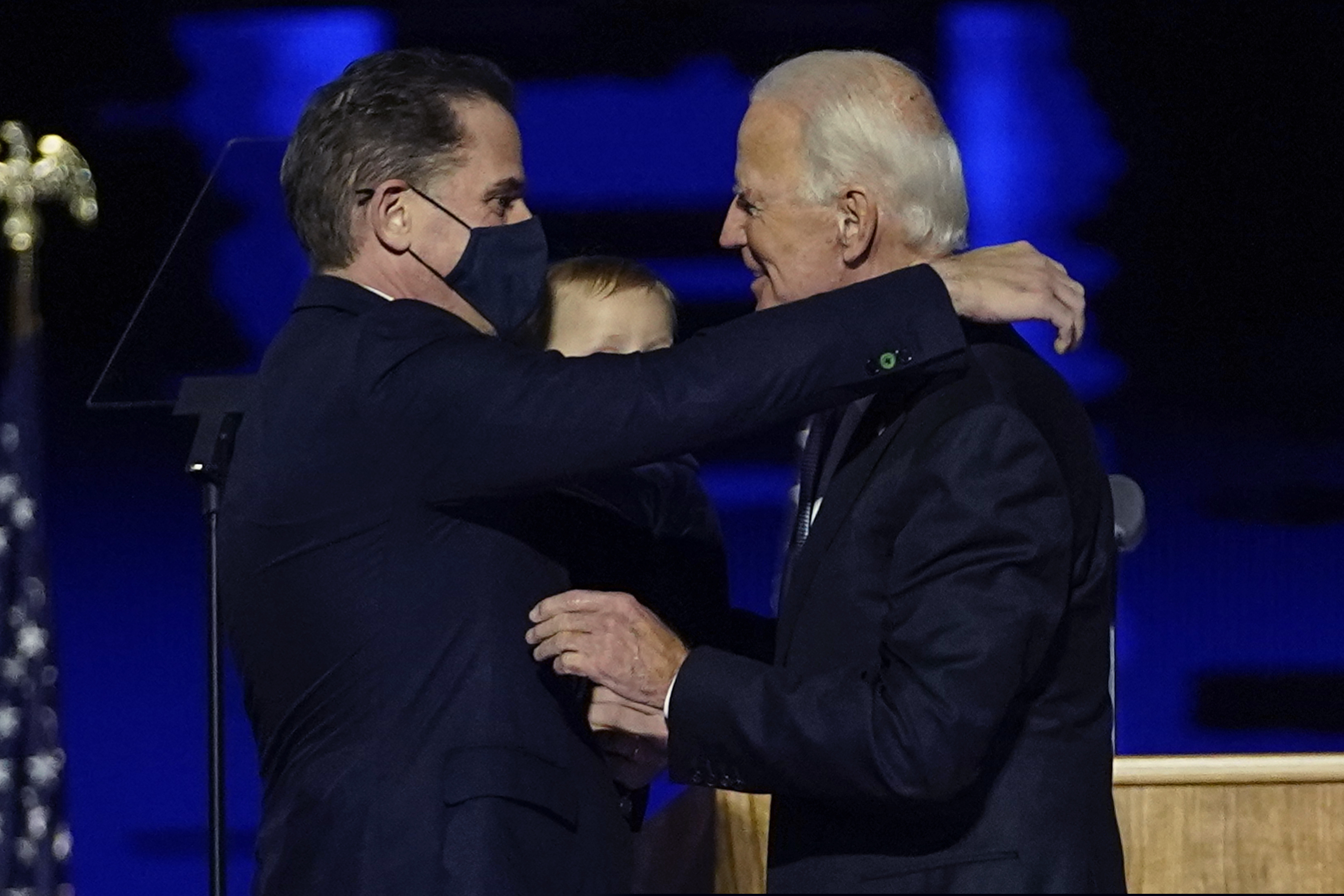 President-elect Joe Biden, right, embraces his son Hunter Biden, left, in Wilmington, Del., in November. Biden’s son Hunter says he has learned from federal prosecutors that his tax affairs are under investigation.