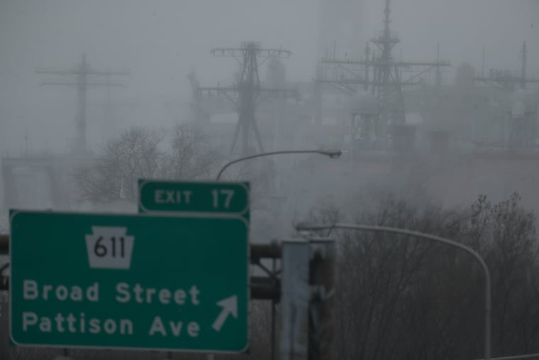 Fog and drizzle obscure ships that are dry docked at the Philadelphia Navy Yard last December. Fog could freeze on roads and some surfaces Friday morning.