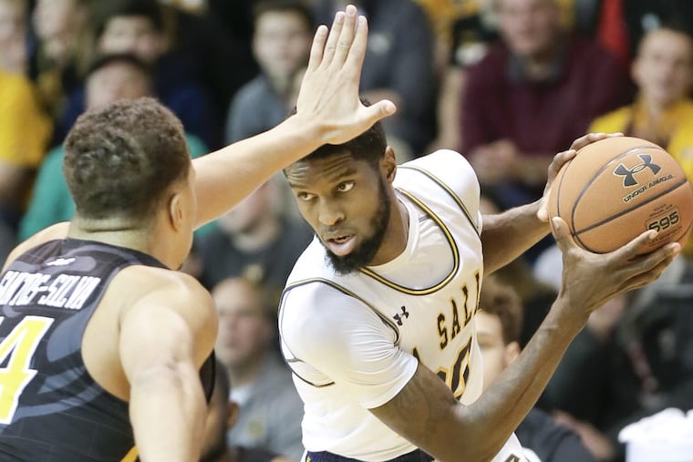 VCU's Marcus Santos-Silva and La Salle's B.J. Johnson go head-to-head in the first half Saturday.